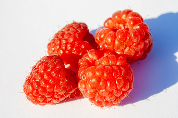 Closeup shot of raspberries on a white background