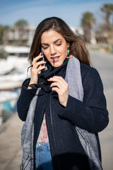 Business woman talking to the phone and bites her glasses