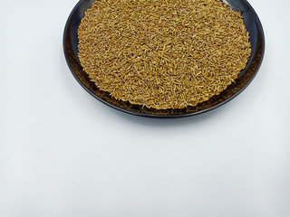 Pile of cumin seeds isolated on white background