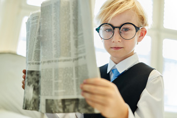 Child as a businessman with a daily newspaper
