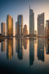 Amazing architecture parallel buildings. Cloudy night sky. Luxury travel inspiration. Dubai Jumeirah Lake Towers.