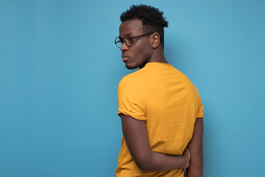 Black Man In Glasses And Yellow T-shirt Turning Back.