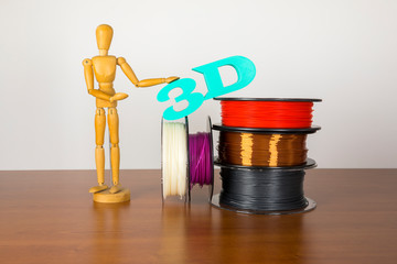 3D printing filament reels with wooden anthropomorphic doll with text 