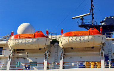 Orange lifeboats on the deck of ferry.