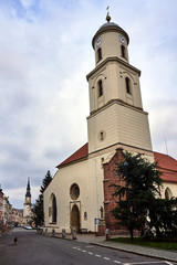 Naklejka premium Church bell tower and town hall tower in the city of Bolków in Poland.