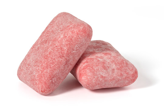 Two pads of pink strawberry chewing gum on a white background