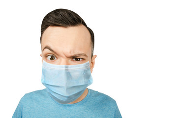 Unhappy, sad young guy, wearing a protective face mask prevent virus infection or pollution on white isolated background