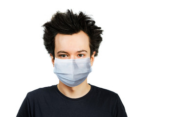 Unhappy, mad young man wearing a protective face mask prevent virus infection or pollution on white isolated background