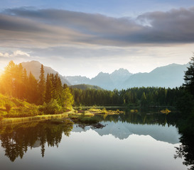 Calm mountain lake in National Park High Tatra. Location place Strbske pleso, Slovakia, Europe.