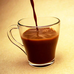 A stream of cocoa pours into a cup