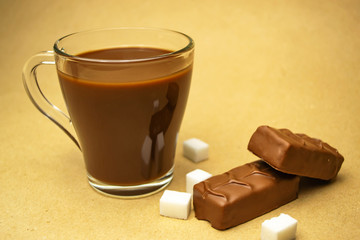 Cup with cocoa, refined sugar and chocolate bars
