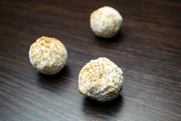 Three white truffles on a black background