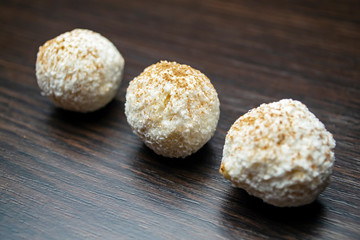 Three white truffles on a black background