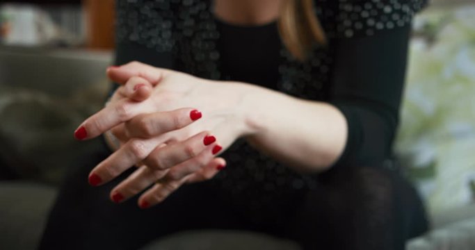 The hands of a young woman with painted nails