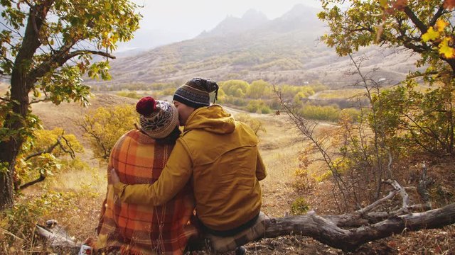 couple on a picnic in the mountains on an autumn day