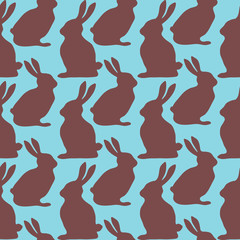 Chocolate Easter rabbits a on blue background. Seamless pattern. Vector illustration .