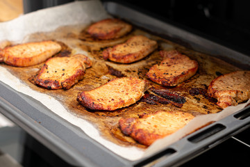 Tasty roasted meat steaks in oven