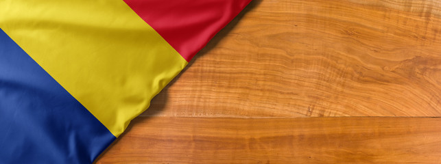 National flag of Romania on a wooden background with copy space