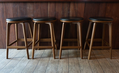 Row of wooden chairs or stools vintage in front of counter bar interior retro style decoration