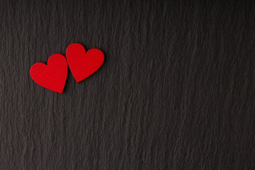 Obraz premium Romantic Love Greeting Card Banner Poster with Copy Space . Two Red Hearts on Dark Stone Background.
