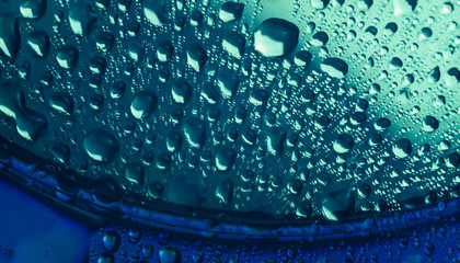 Fototapeta na wymiar Close up beautiful colored water drops on a cd disk background.