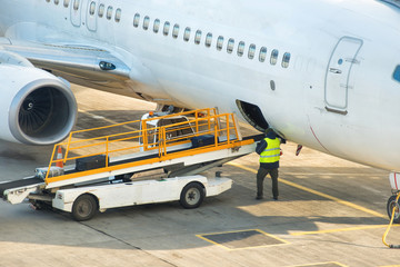 Airport service. Preparation for unloading baggage from an airplane standing on airfield