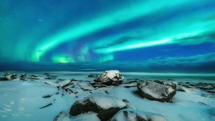 Fotobehang Aurora borealis over Uttakleiv beach on Lofoten Islands in Norway during spring month March. 16:9 ration for display monitor background. © Feel good studio