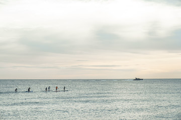 Group of people doing paddle surf in the Mediterranean sea. Barcelona, Spain.