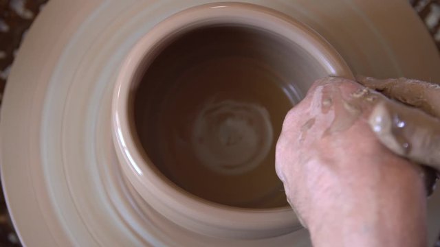 Process of manufacturing clay crockery by potter in potery workshop.