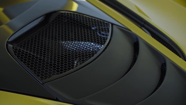 Modern yellow supercar engine bay hood with air intake 