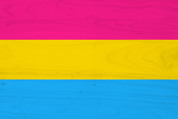 A pansexual flag on with wood texture