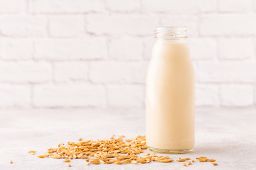 A bottle of oat milk and oats.