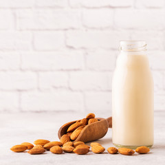 A bottle of almond milk and almonds