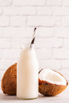 A Bottle Of Coconut Milk And Coconut