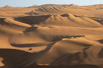 Fototapeta na wymiar Buggy on sand dunes near Hucachina, Ica, Peru