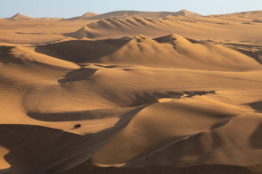 Buggy on sand dunes near Hucachina, Ica, Peru