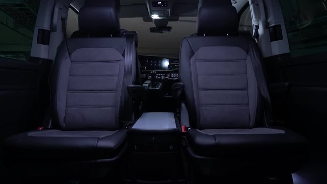 Luxury leather seats in the comfortable van. Interior of luxury minivan with backlight, transfer car