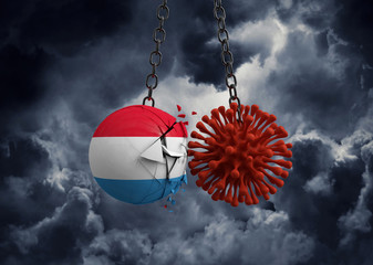 Obraz premium Virus microbe smashing into Luxembourg flag ball. 3D Render