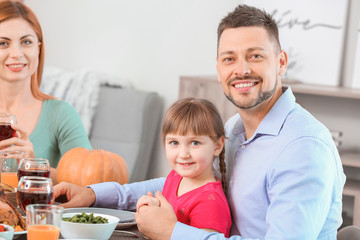 Father with daughter celebrating Thanksgiving Day at home