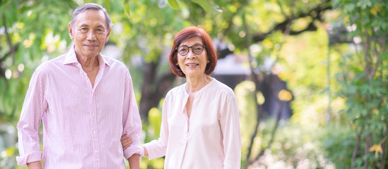 Asian elderly couple together in the park.Retirement happy  lifestyle concept.banner ratio