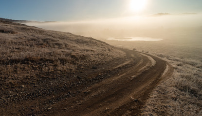 Autumn mountains at sunrise in the fog