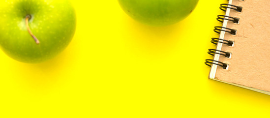 Green apple on yellow background flat layout view.healthy recipe concept