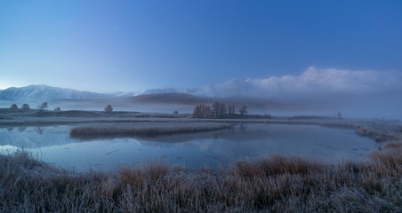 Foggy morning on a mountain lake
