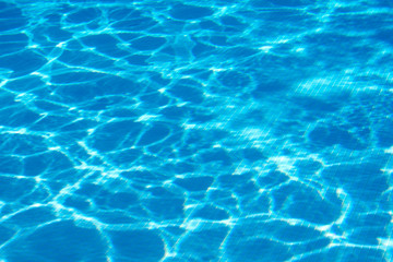 Fototapeta na wymiar Sun glare at the bottom of the pool. Fragment pool background