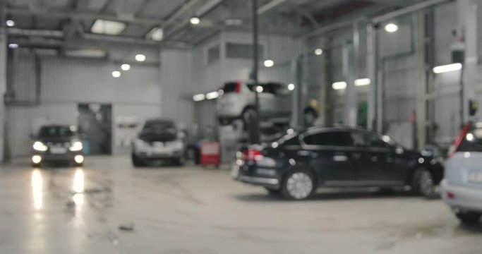 Car Service Station With Vehicles. Real Working Day. Blurred Background