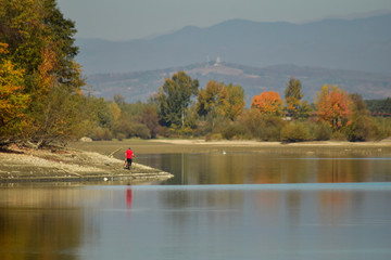 Man searching for shells on lake