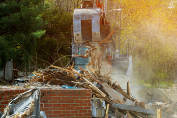 Excavator Demolition of an old house building for new construction project.