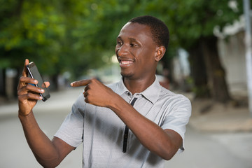 close-up of a happy young man with mobile phone.