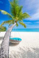 Tropical beach background as summer landscape with beach swing or hammock and white sand and calm sea for beach banner. Perfect beach scene vacation and summer holiday concept. Boost up color process
