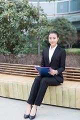 female staff holding a folder
